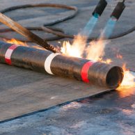 torches heating roofing material